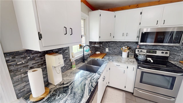 2251 W Stone Bluff Rd, Covington, IN 47932 - kitchen with appliances with stainless steel finishes, tasteful backsplash, light stone countertops, and white cabinets