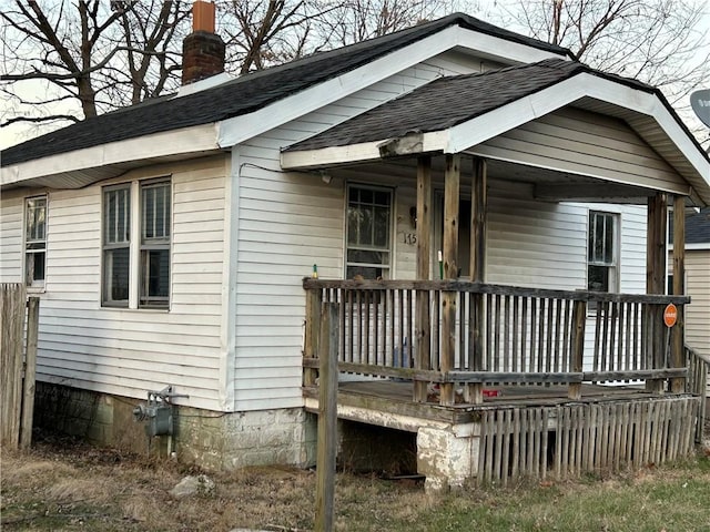 rear view of house featuring a porch