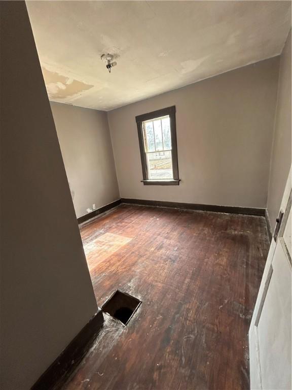 unfurnished room with hardwood / wood-style flooring