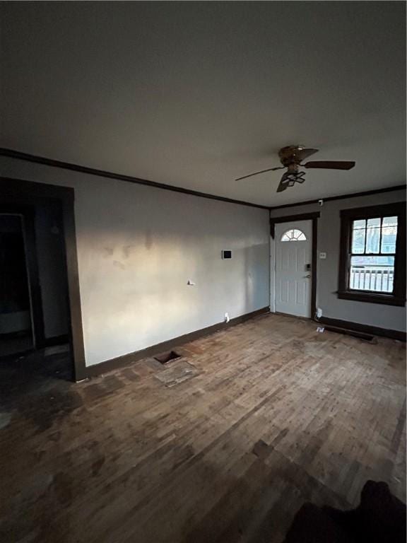 foyer entrance with ceiling fan, crown molding, and hardwood / wood-style floors