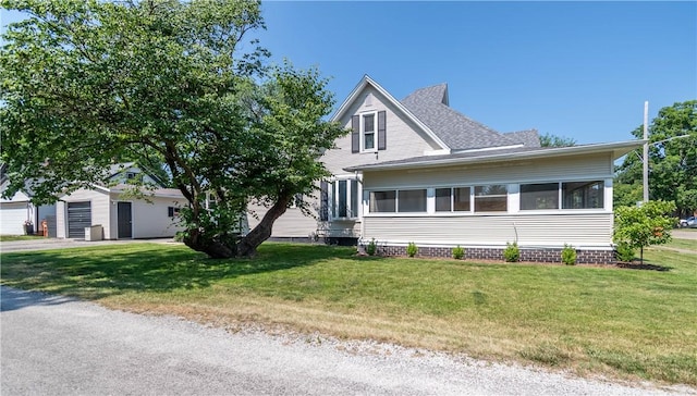 503 W Harrison St, Sullivan, IL 61951 - view of front facade featuring a front lawn, a garage, and roof with shingles