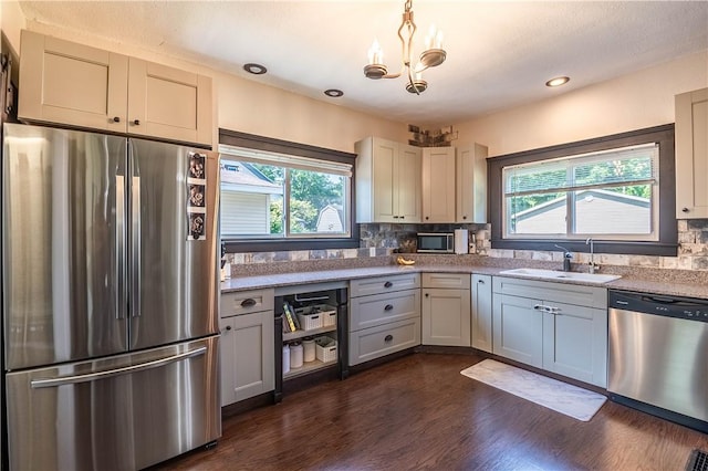 503 W Harrison St, Sullivan, IL 61951 - kitchen featuring stainless steel appliances, plenty of natural light, decorative backsplash, a chandelier, and recessed lighting