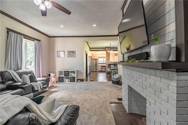 503 W Harrison St, Sullivan, IL 61951 - living room featuring dark carpet, a ceiling fan, crown molding, a fireplace, and recessed lighting