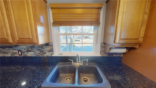 kitchen featuring tile countertops, a sink, and decorative backsplash