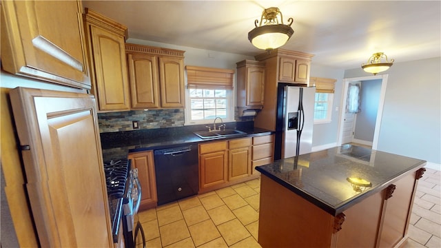 kitchen featuring dark countertops, appliances with stainless steel finishes, and a sink