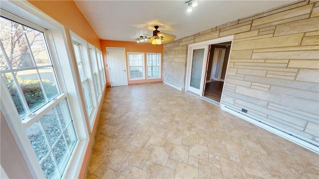 unfurnished sunroom with a ceiling fan