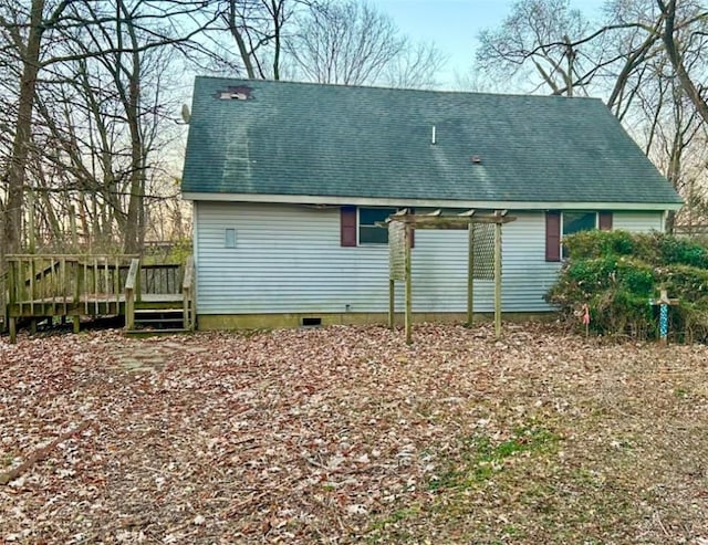 rear view of property featuring a wooden deck