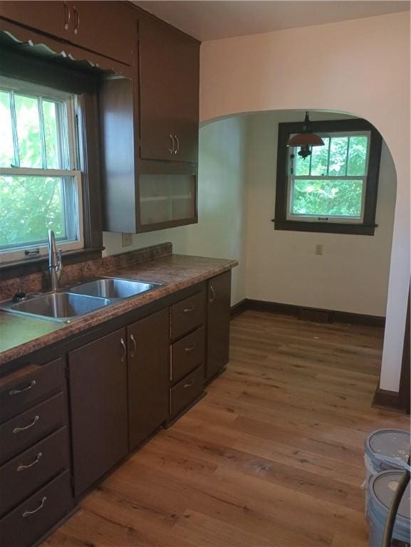 920 Garfield Pl, Danville, IL 61832 - kitchen with wood finished floors, arched walkways, dark brown cabinets, and dark countertops