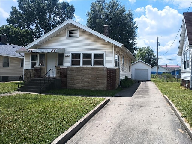 920 Garfield Pl, Danville, IL 61832 - bungalow-style house featuring stone siding, a front yard, concrete driveway, a garage, and a chimney
