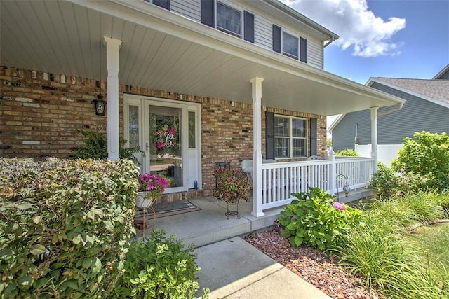 737 Phillip Cir, Forsyth, IL 62535 - property entrance featuring covered porch and brick siding