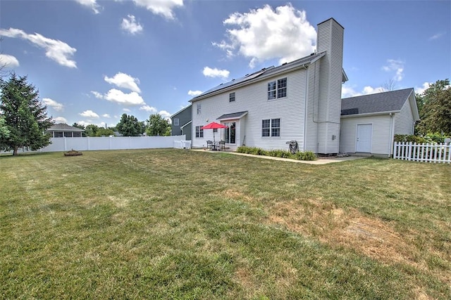 737 Phillip Cir, Forsyth, IL 62535 - back of house featuring a fenced backyard, a patio area, and a chimney