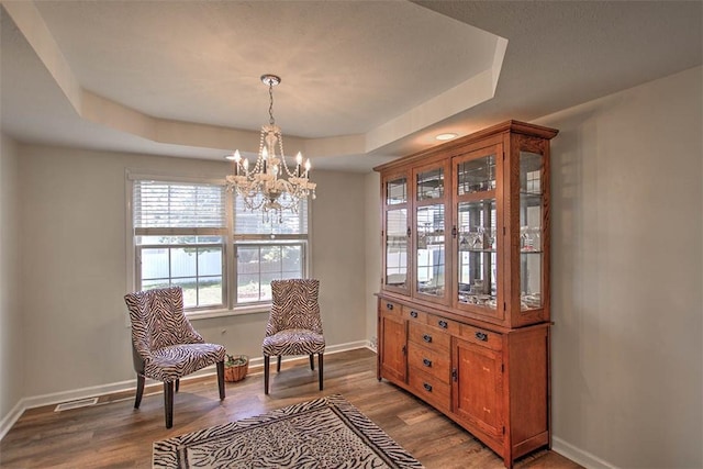 737 Phillip Cir, Forsyth, IL 62535 - sitting room featuring a chandelier, a raised ceiling, and wood finished floors