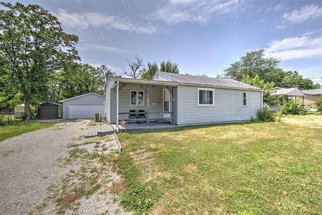 2645 E Logan St, Decatur, IL 62526 - view of front of property featuring an outbuilding, a garage, a front yard, and a porch