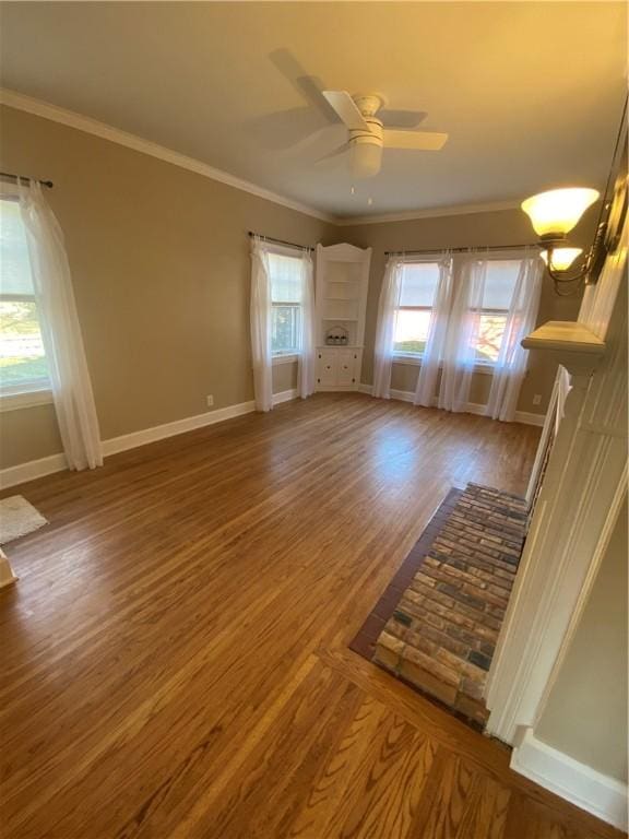 unfurnished living room featuring hardwood / wood-style floors, ceiling fan, and ornamental molding