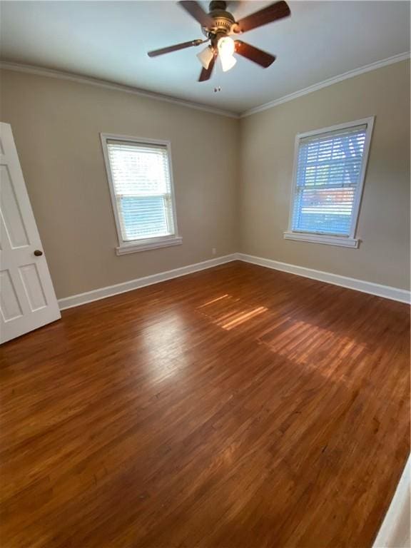 spare room featuring crown molding, dark hardwood / wood-style flooring, and ceiling fan