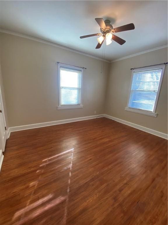 empty room with ceiling fan, dark hardwood / wood-style flooring, and crown molding