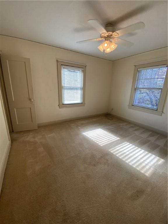 empty room with light carpet and ceiling fan