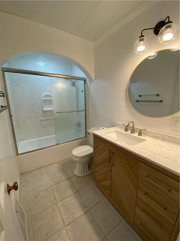 full bathroom with vanity, toilet, shower / bath combination with glass door, and ornamental molding