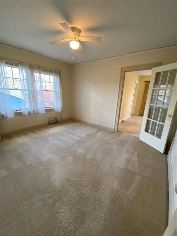 spare room featuring ceiling fan and carpet floors