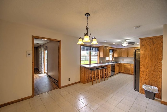 335 E Walnut St, Dalton City, IL 61925 - kitchen featuring dishwashing machine, a sink, baseboards, a chandelier, and decorative light fixtures