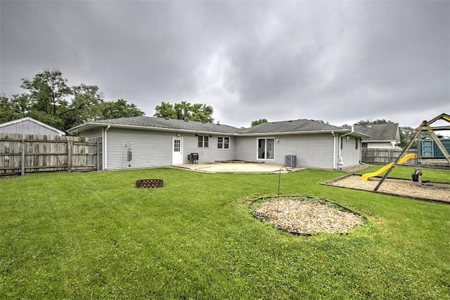 335 E Walnut St, Dalton City, IL 61925 - rear view of house with a playground, a patio area, cooling unit, and a fire pit