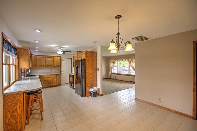 335 E Walnut St, Dalton City, IL 61925 - kitchen featuring black appliances, light countertops, baseboards, a chandelier, and a ceiling fan