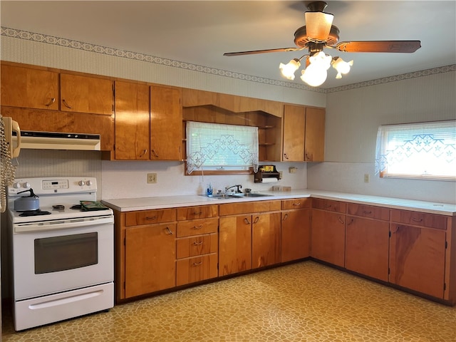 kitchen with white range with electric stovetop, ceiling fan, and sink