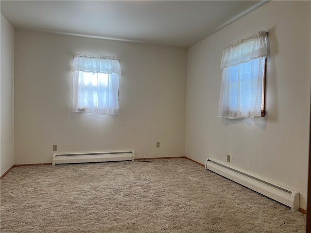 empty room featuring carpet and a baseboard heating unit