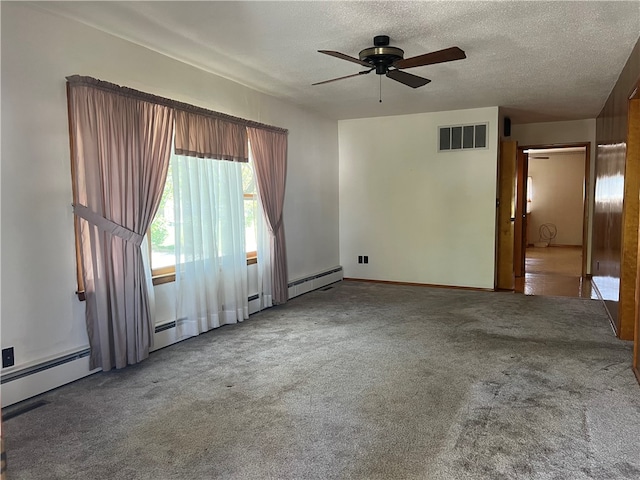 spare room featuring ceiling fan, carpet, a baseboard radiator, and a textured ceiling