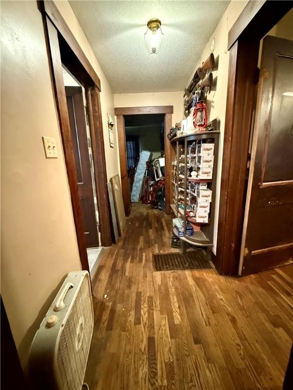 124 Polk Ave, Charleston, IL 61920 - hallway with wood finished floors and a textured ceiling