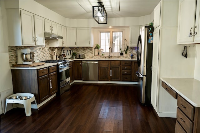 kitchen featuring white cabinets, appliances with stainless steel finishes, dark hardwood / wood-style flooring, and sink