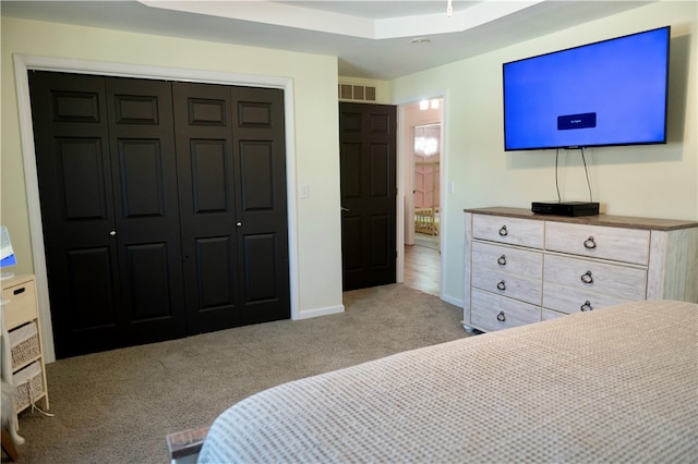 bedroom with light carpet and a closet