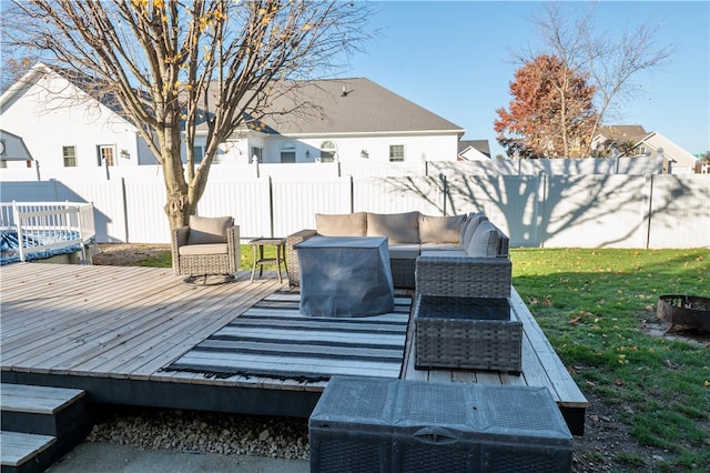 deck with outdoor lounge area and a yard