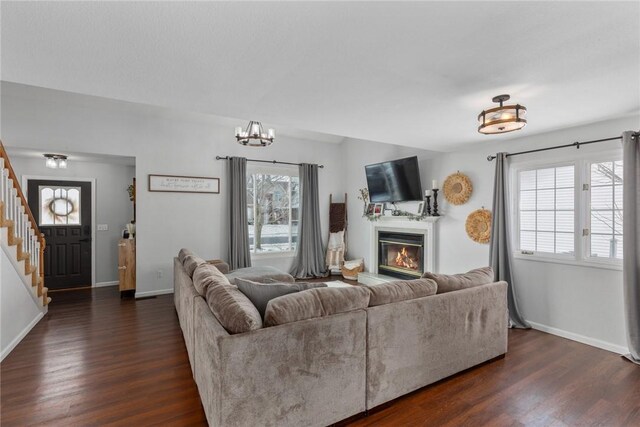 living room featuring dark hardwood / wood-style floors and an inviting chandelier