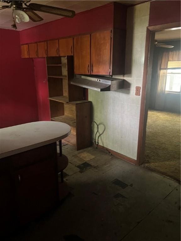 705 Orlando Dr, Robinson, IL 62454 - kitchen featuring under cabinet range hood, ceiling fan, and brown cabinetry