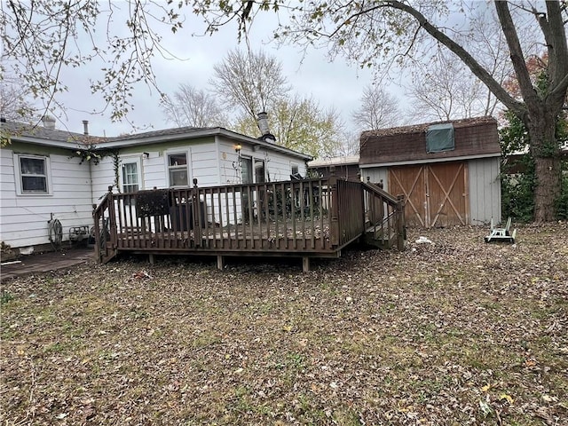 705 Orlando Dr, Robinson, IL 62454 - rear view of property featuring a wooden deck and a storage unit