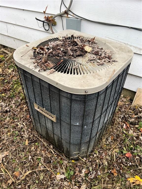 705 Orlando Dr, Robinson, IL 62454 - exterior view of a central AC unit and a fire pit