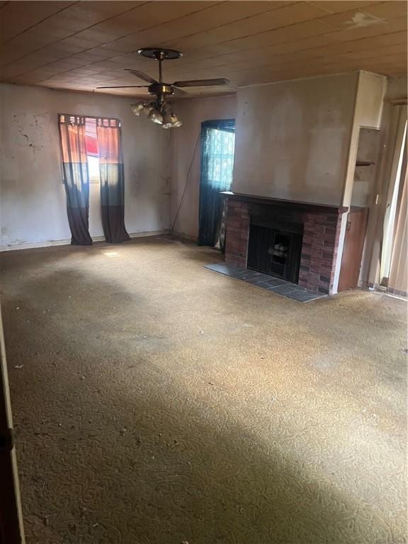 705 Orlando Dr, Robinson, IL 62454 - unfurnished living room with healthy amount of natural light, a ceiling fan, a fireplace, and carpet flooring