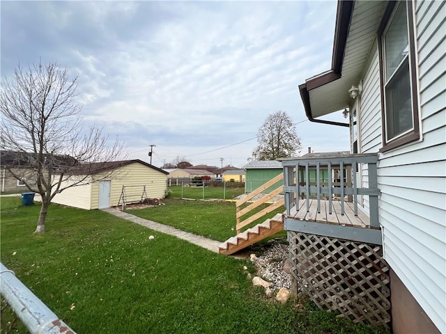 view of yard featuring an outdoor structure and a wooden deck