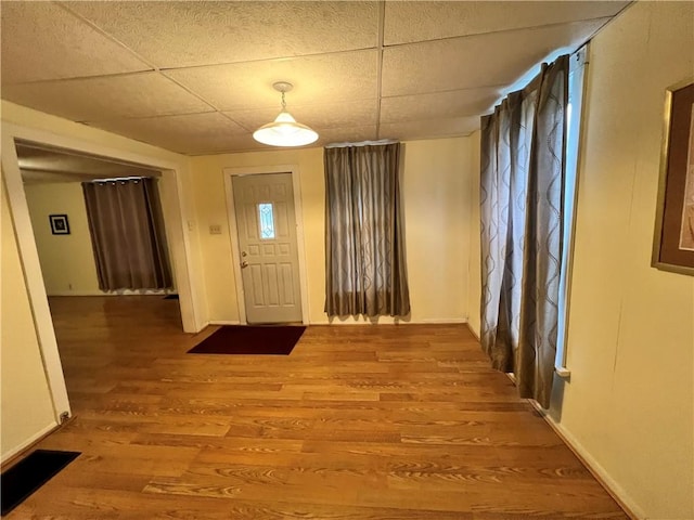 foyer featuring a paneled ceiling and hardwood / wood-style flooring