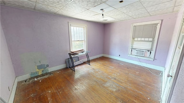 616 Griffin St, Danville, IL 61832 - spare room featuring cooling unit, hardwood / wood-style floors, and a drop ceiling