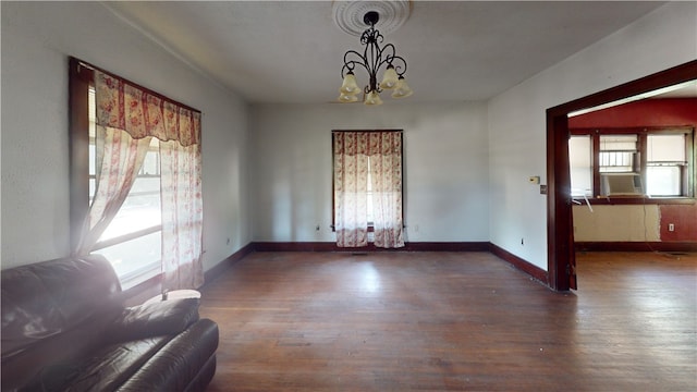 616 Griffin St, Danville, IL 61832 - unfurnished dining area featuring wood finished floors, a chandelier, and cooling unit