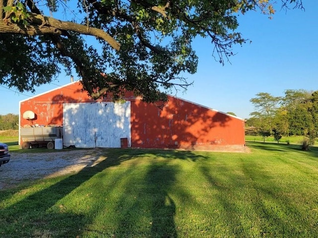 view of outbuilding featuring a lawn