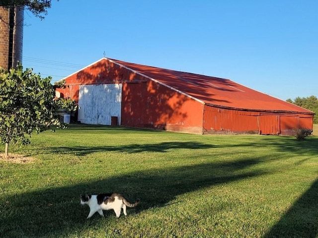 view of outbuilding featuring a lawn