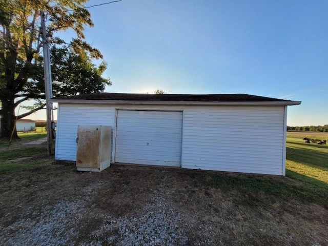 view of garage at dusk