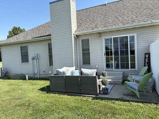 34A Woolery Dr, Neoga, IL 62447 - rear view of property with an outdoor hangout area, a chimney, a yard, a shingled roof, and a patio area
