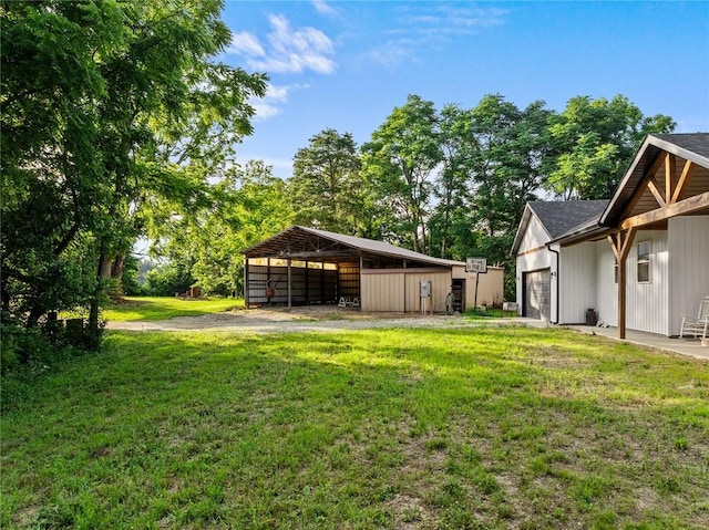 25760 E 1750th Rd, Marshall, IL 62441 - view of grassy yard featuring a garage and a pole building