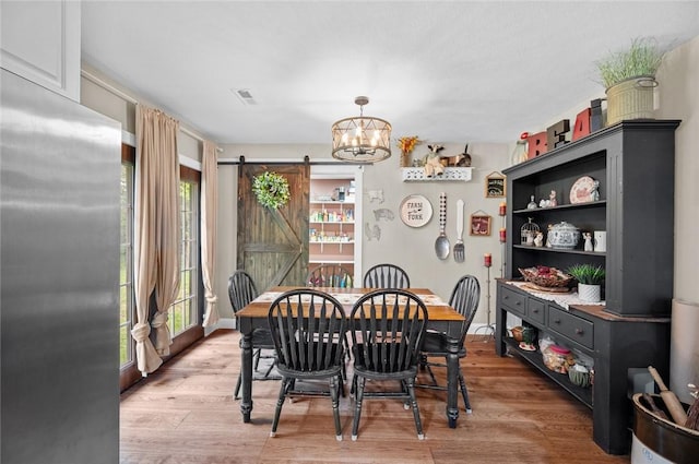 25760 E 1750th Rd, Marshall, IL 62441 - dining room with a barn door, a chandelier, and light wood finished floors