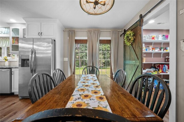 25760 E 1750th Rd, Marshall, IL 62441 - dining area featuring a barn door and wood finished floors