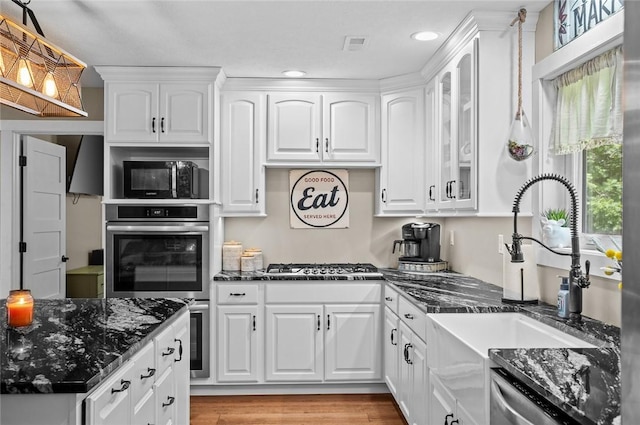 25760 E 1750th Rd, Marshall, IL 62441 - kitchen featuring appliances with stainless steel finishes, white cabinetry, dark stone counters, recessed lighting, and glass insert cabinets